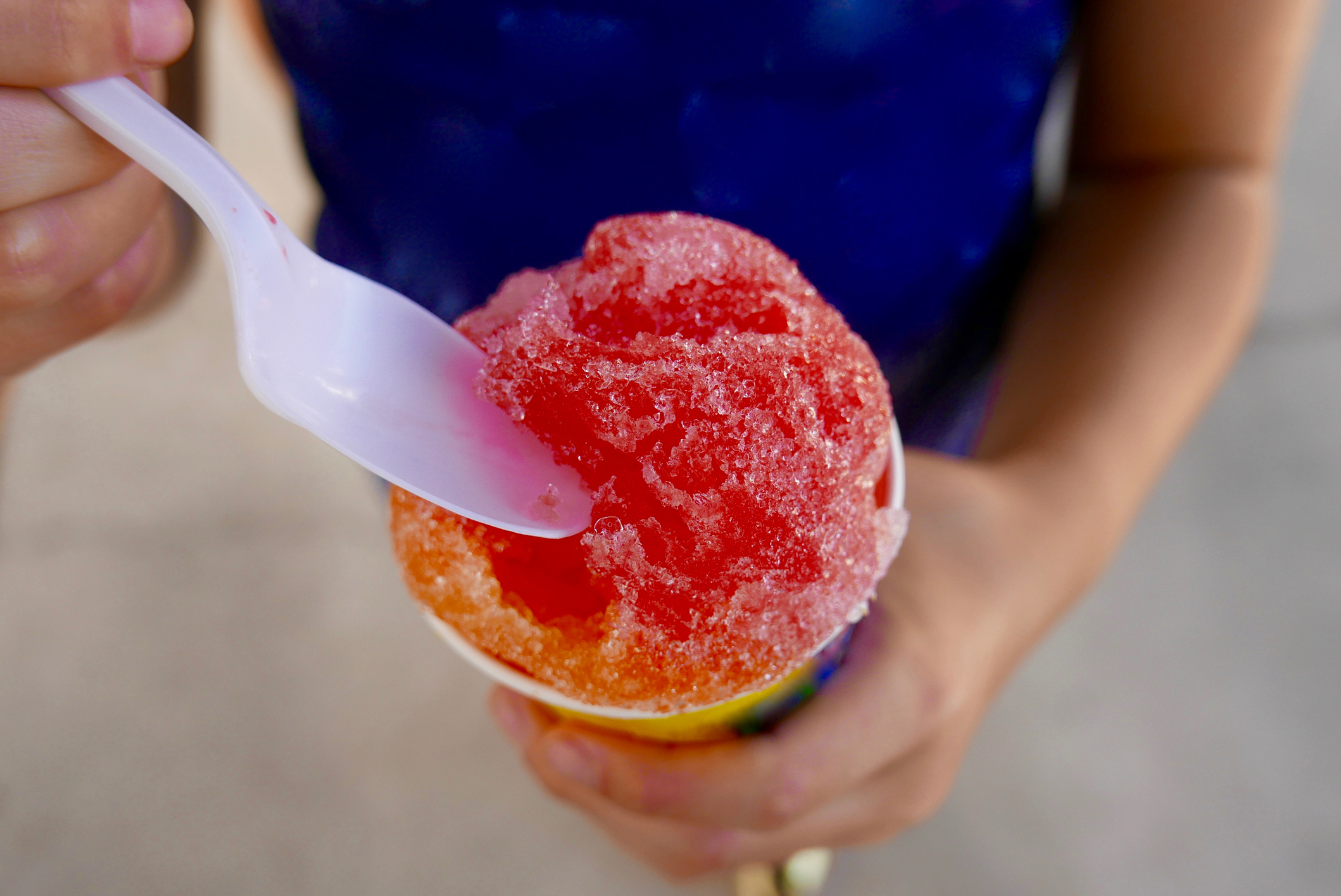 Close up of snow cone held by a child