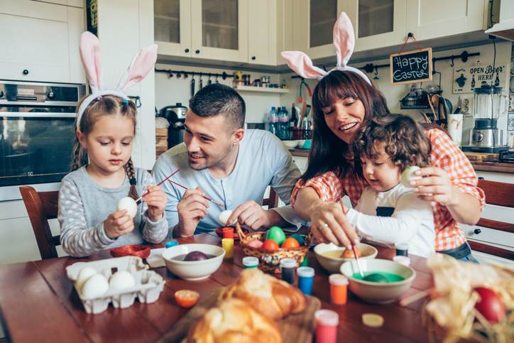 Happy family painting Easter eggs