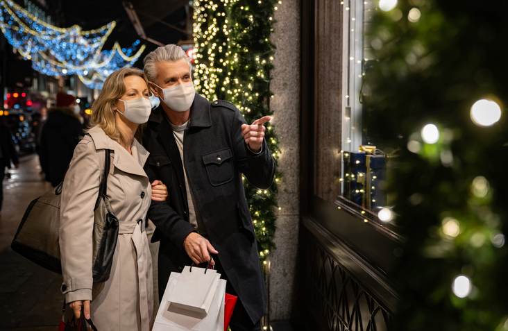 Couple Christmas shopping wearing a facemask in London